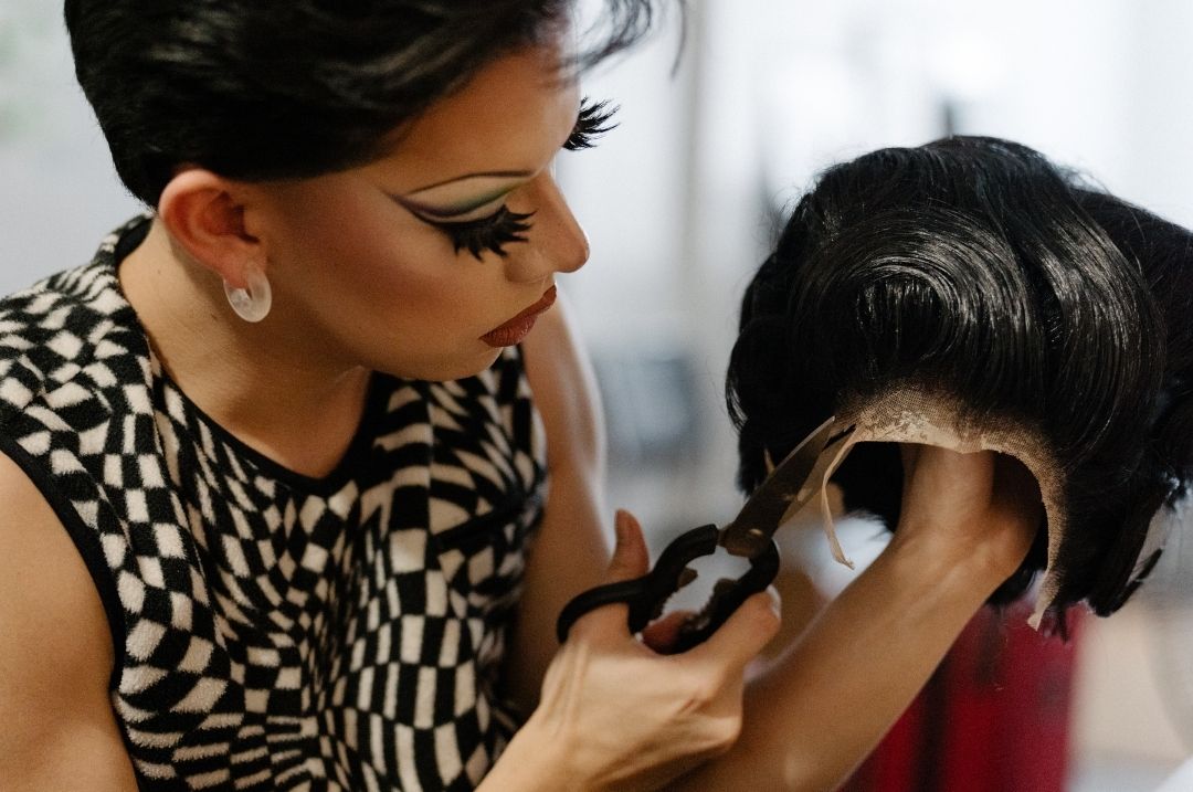 a stylist cutting the lace of a 360 lace wig