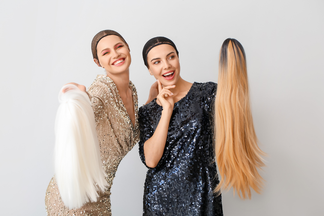 2 women holding handmade wigs (hand tied wigs)