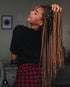 a black african american woman wearing a braided wig