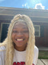 a black african american woman wearing a blonde braided wig